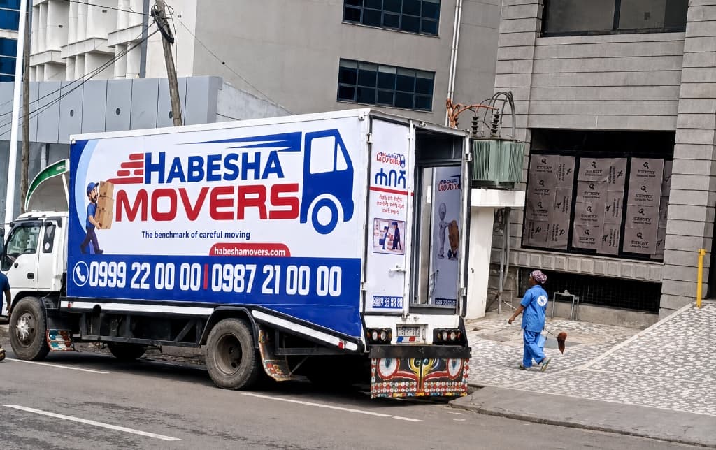 Habesha Movers branded truck parked outside a building in Addis Ababa ready for a house move